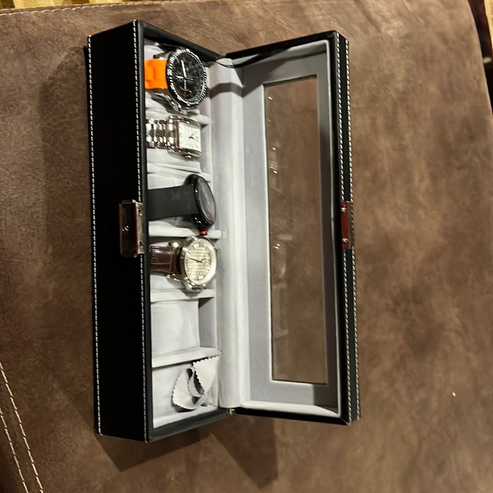 Watch case with four watches included.
